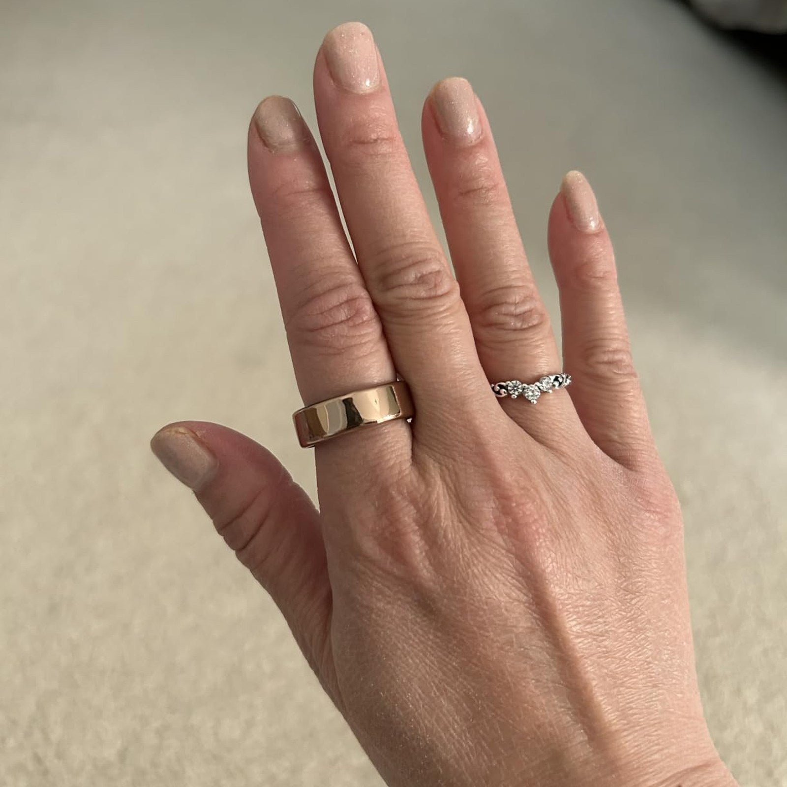 Rose-gold Oura Ring cover photographed in natural daylight